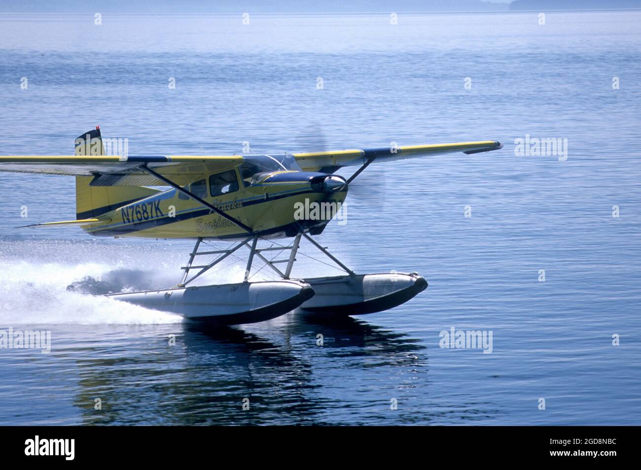 Cessna 180 floatplane landing in Frederick Sound in SE Alaska Stock Photo