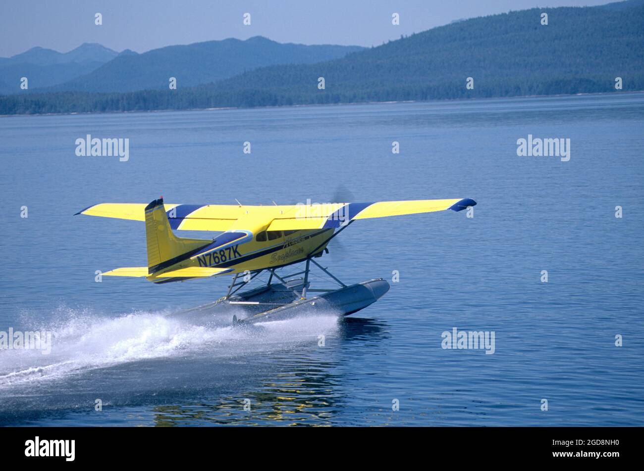 Cessna 180 floatplane taking off in Frederick Sound in SE Alaska Stock Photo