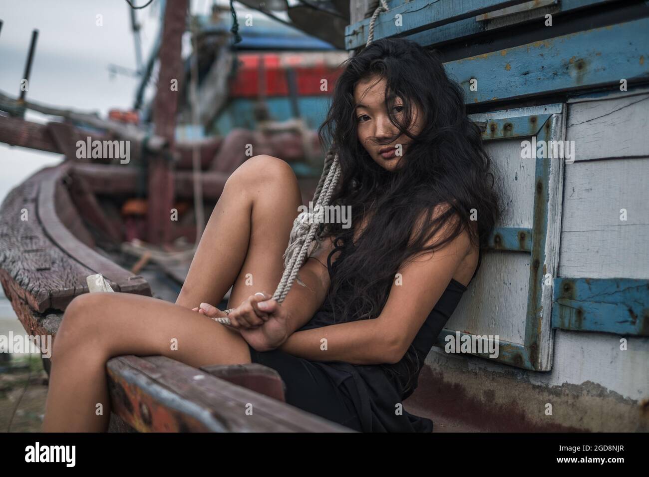 Street style portrait. Black long curly hair. Looking at camera with copy space. Wind in her hair. . High quality photo Stock Photo