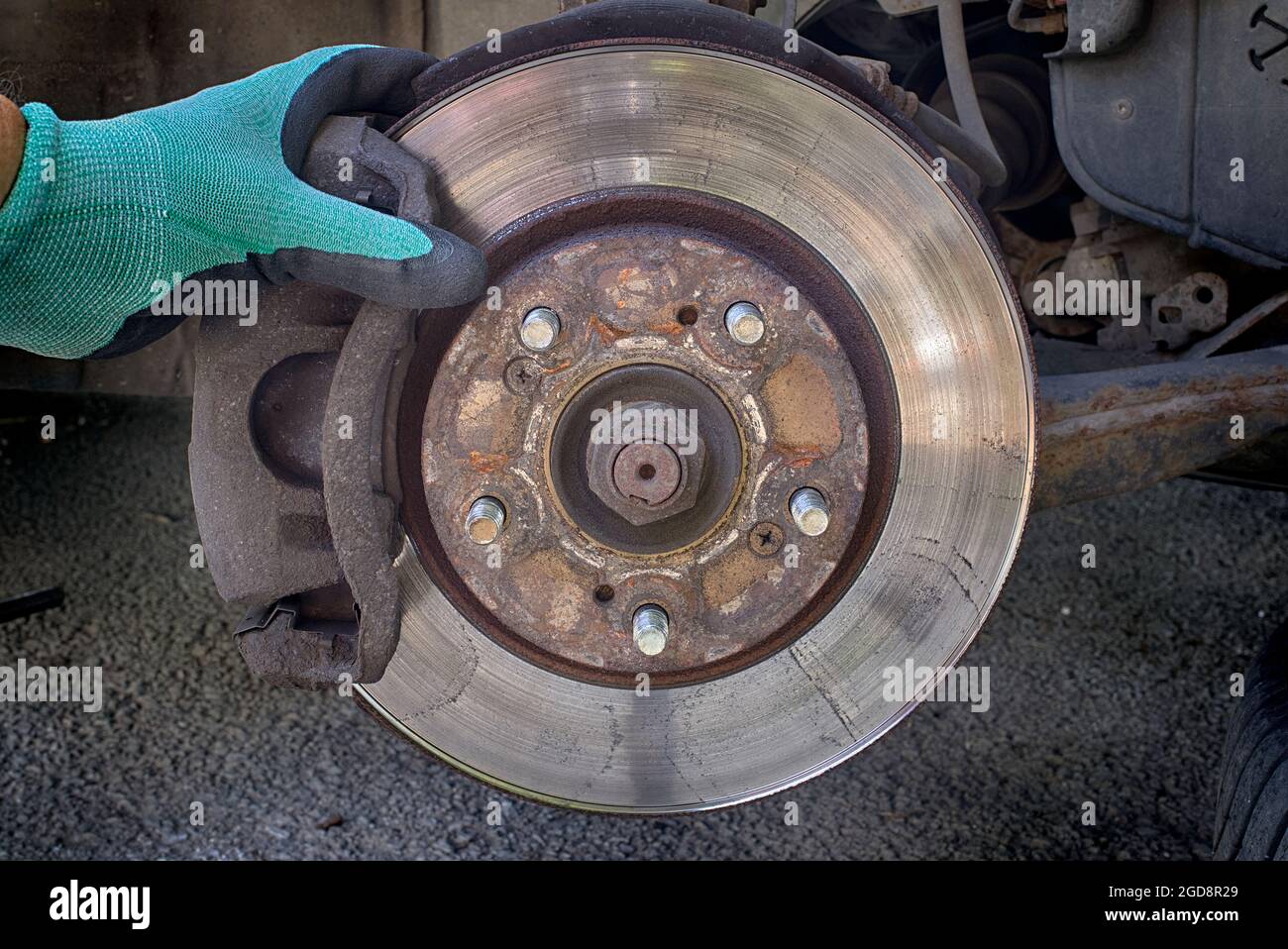 Car disk brake pad replacement service with hand of mechanic, brake