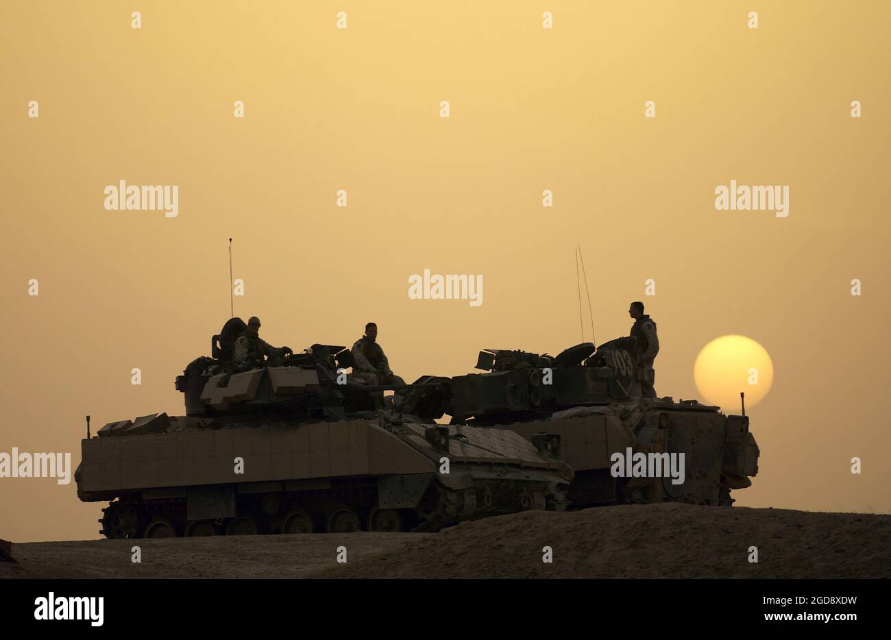 A US Army (USA) Soldiers assigned to Charlie Troop, 1-4 Cavalry, 1st Infantry Division take a break from a combat security patrol on their M3A2 Bradley Cavalry Fighting Vehicles (CFV), outside of Samarra, near Ad Dwr, Iraq, during Operation IRAQI FREEDOM.  (USAF PHOTO BY SSGT SHANE A. CUOMO 041117-F-2034C-019) Stock Photo