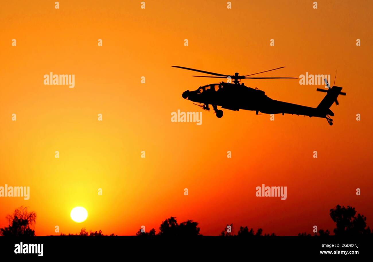 A US Army (USA) AH-64 Apache attack helicopter lands with the sun low over Camp Taji, Iraq (IRQ), during Operation IRAQI FREEDOM.  Apaches provide air support for ground forces during search operations.  (USAF PHOTO BY TSGT RUSSELL E. COOLEY IV 050723-F-9712C-011) Stock Photo