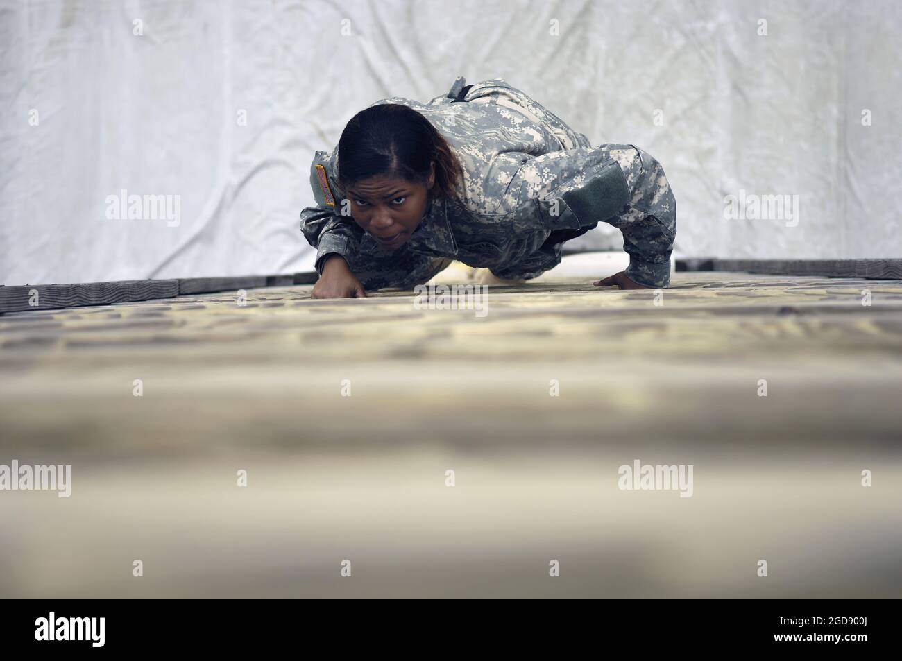 A female US Army (USA) Recruit (Soldier-in-training) climbs the Victory Tower vertical wooden ladder during the Red Phase (the two weeks of nine) of Basic Combat Training (BCT) at Fort Jackson, Columbia, South Carolina (SC).  (USAF PHOTO BY SSGT STACY L PEARSALL 060614-F-7234P-031) Stock Photo