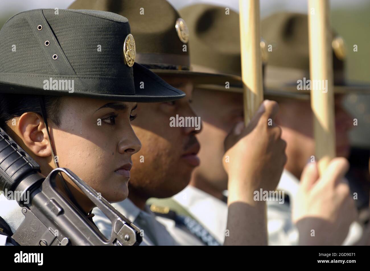 A female US Army (USA) Drill Sergeant (left) provides security for the Color Guard as they post the colors at the start of the graduation ceremony for the Recruits (Soldiers-in-training) graduating at the end of the nine-week Basic Combat Training (BCT) program at Fort Jackson, Columbia, South Carolina (SC).  (USAF PHOTO BY SSGT STACY L PEARSALL 060616-F-7234P-047) Stock Photo