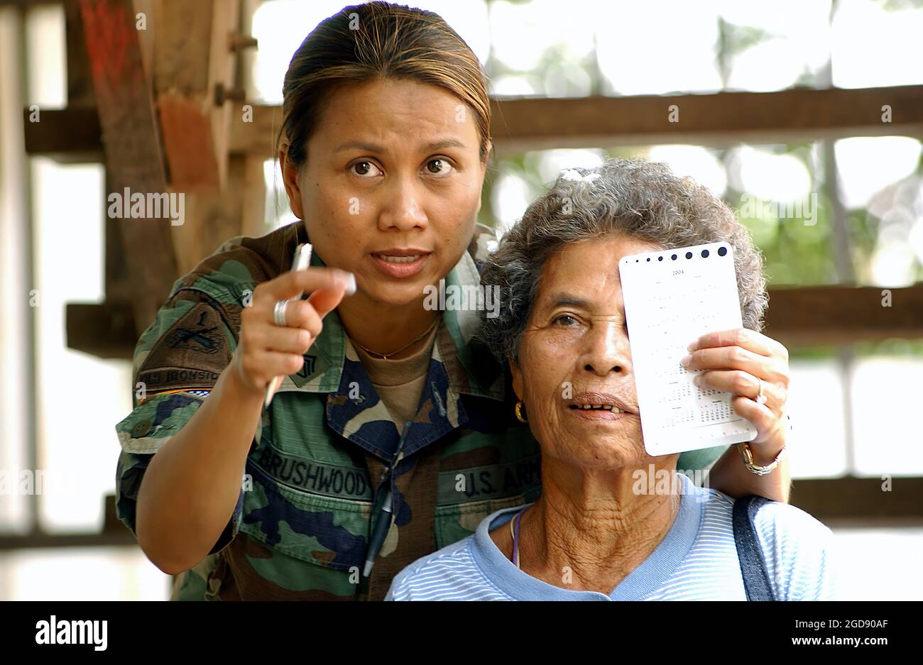 US Army (USA) Staff Sergeant (SSG) Siriporn Brushwood (left), 351st Civil Affairs Command (CAC), gives a local Thai woman an eye exam in order for her to receive a pair of glasses. SSG Brushwood is in the village of Huey Geung, Thailand (THA), participating in a Medical Capabilities (MEDCAP) Exercise being conducted during Exercise COBRA GOLD 2005.  (USAF PHOTO BY SSGT AARON D. ALLMON II 050425-F-7823A-012) Stock Photo