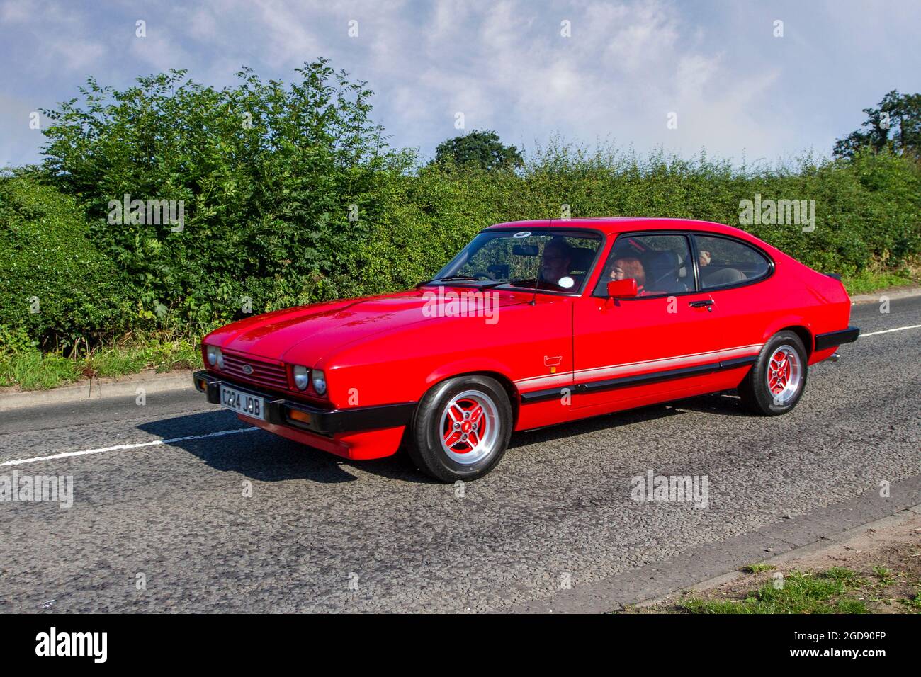 1986 1980s red Ford Capri Laser 2dr coupe en-route to Capesthorne Hall classic July car show, Cheshire, UK Stock Photo