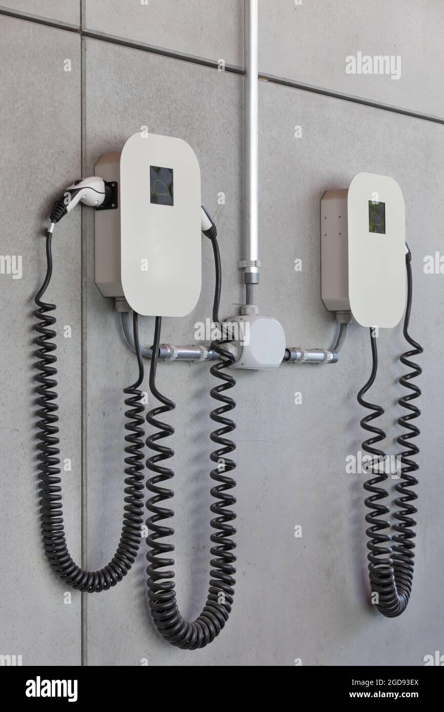 electric charger on concrete wall Stock Photo