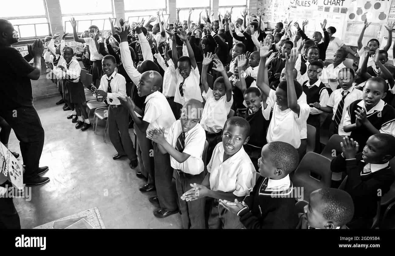 JOHANNESBURG, SOUTH AFRICA - Jan 05, 2021: A grayscale of African students in a primary school classroom in Johannesburg, South Africa Stock Photo