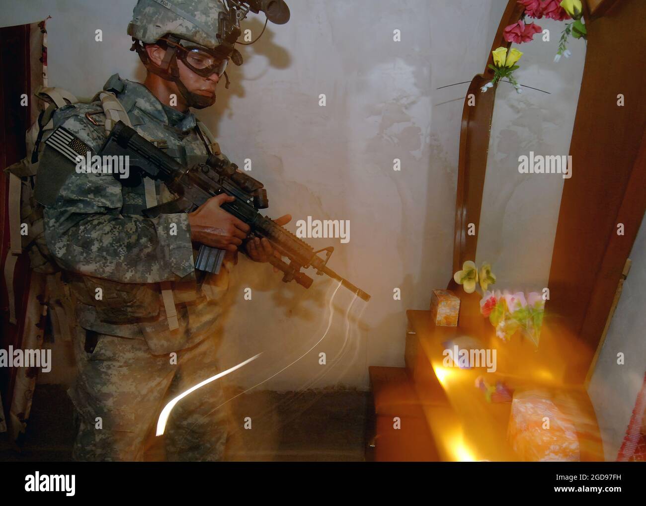 A US Army (USA) Soldier from 7th Squadron (SQN), 10th Cavalry Regiment (CAV REGT), 1st Brigade Combat Team (BCT), 4th Infantry Division (ID), Fort Hood, Texas (TX), searches a residence in Nubai, Iraq, during an air assault mission to search for insurgents and weapons caches during Operation IRAQI FREEDOM. The Soldier is armed with a KAC 5.56 mm Modular Weapon System (MWS) SOPMOD (Special Operation Peculiar Modification) M4.  (US NAVY PHOTO BY MC1(AW) MICHAEL LARSON 060703-N-6901L-069) Stock Photo