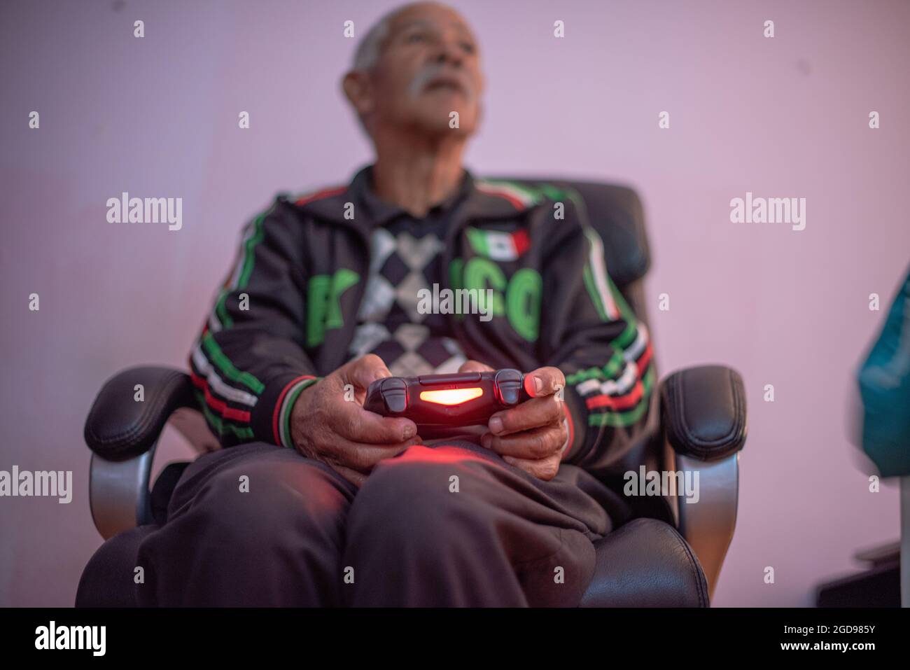 Selective focus of senior man playing video games Stock Photo