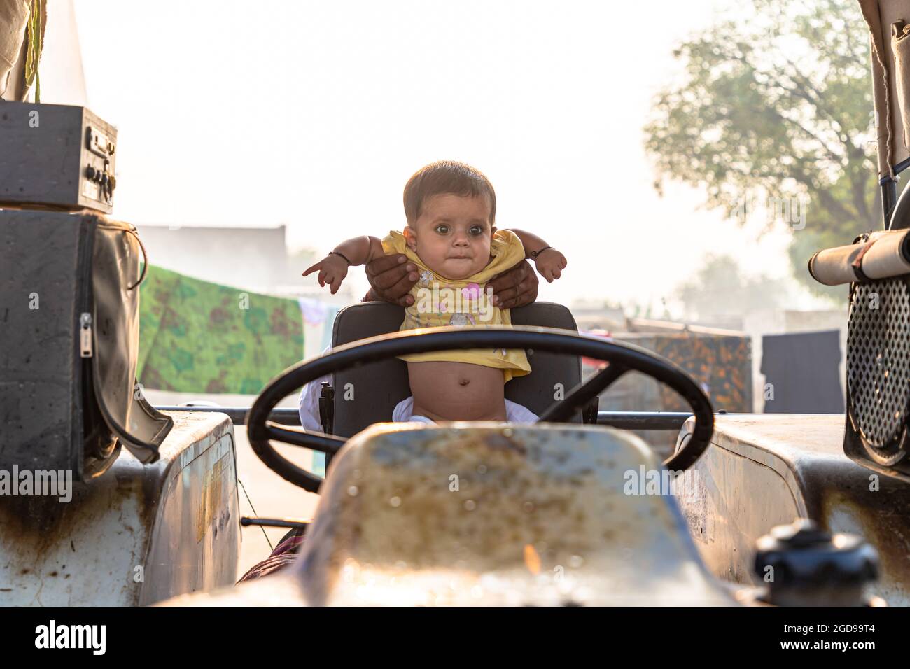 portrait of indian baby girl sitting on tractor seat Stock Photo Alamy