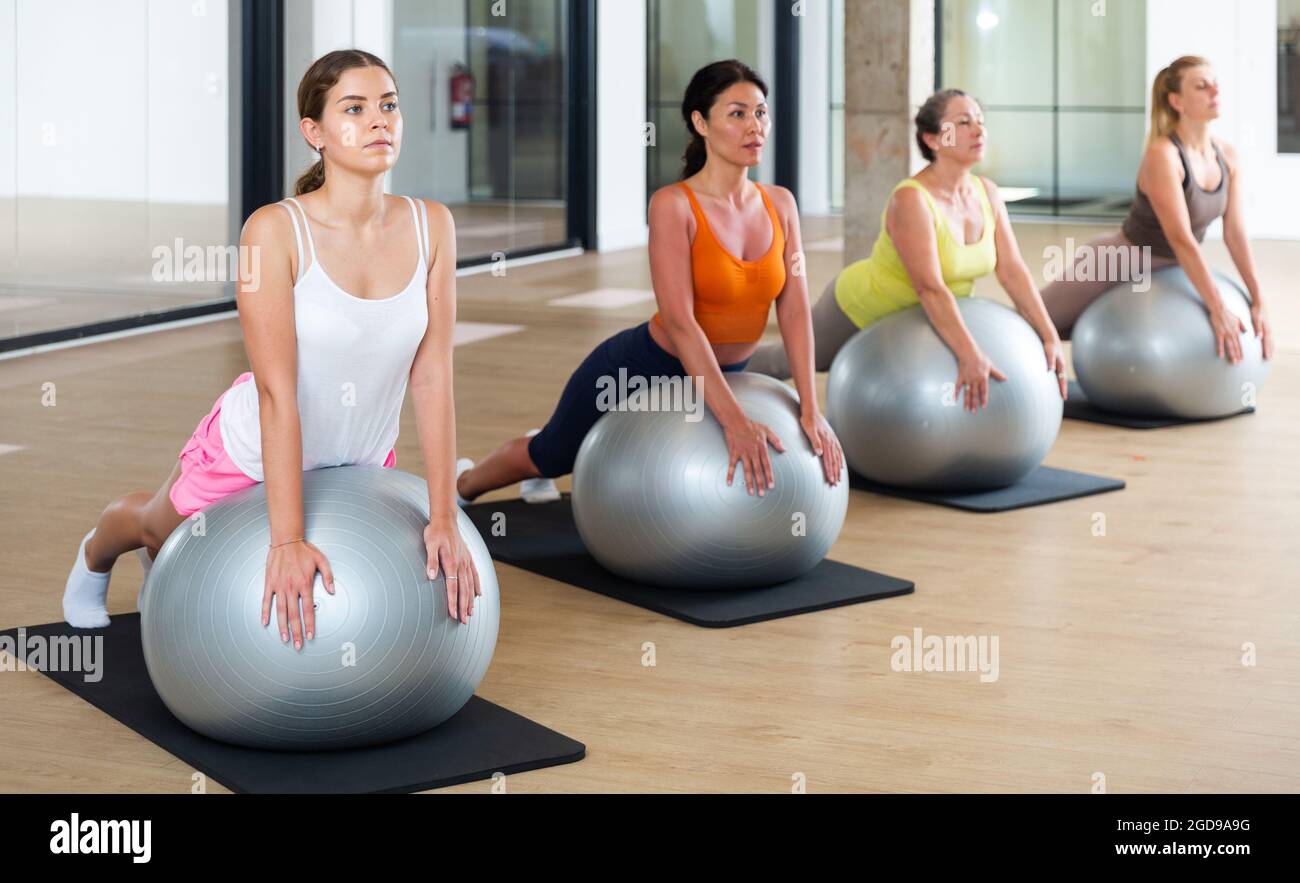 Women during group workout with fitness ball at gym Stock Photo - Alamy