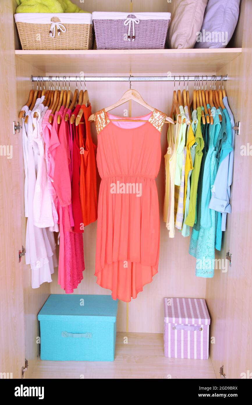 Colorful clothes hanging in wardrobe Stock Photo Alamy