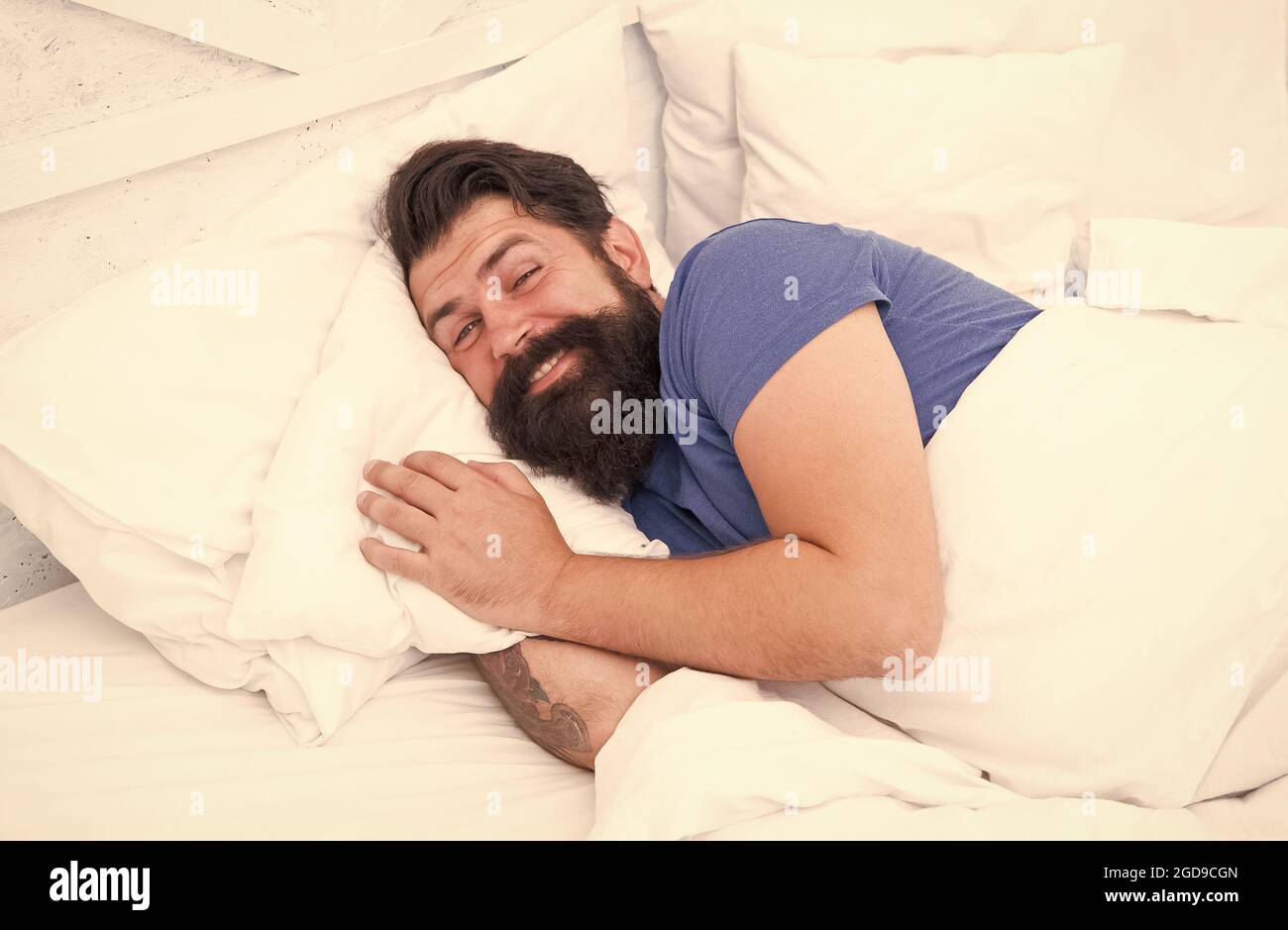 Just relaxing. bachelor feel comfortable. guy at bedroom. lazy sunday. bed time routine. smiling male spending time in room. relax lifestyle. happy be Stock Photo