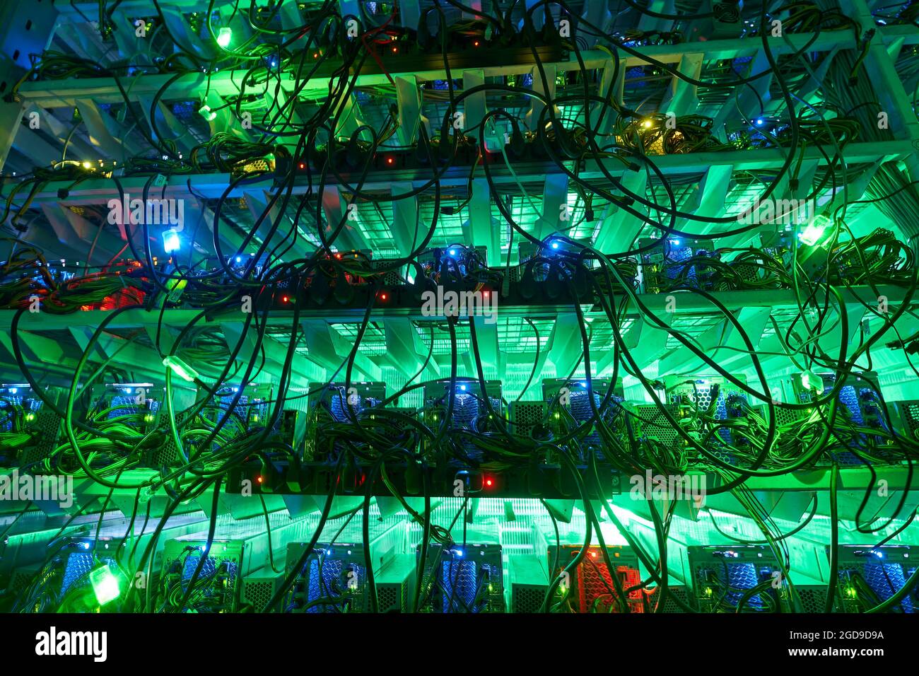 Bitcoin miners in large farm. ASIC mining equipment on stand racks mine ...