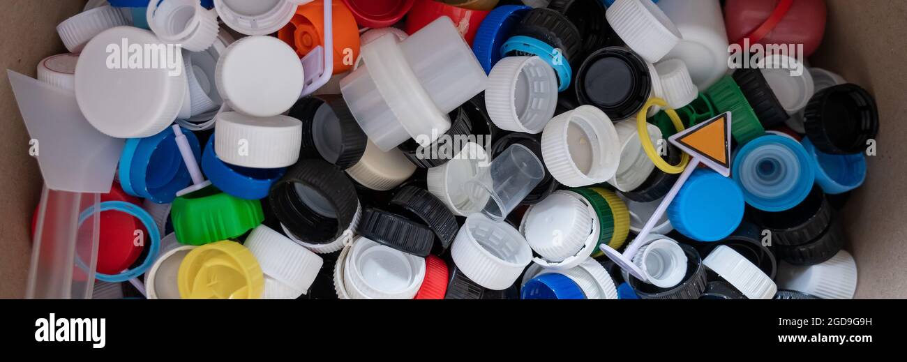 A closeup of many plastic bottle caps collected for recycling Stock