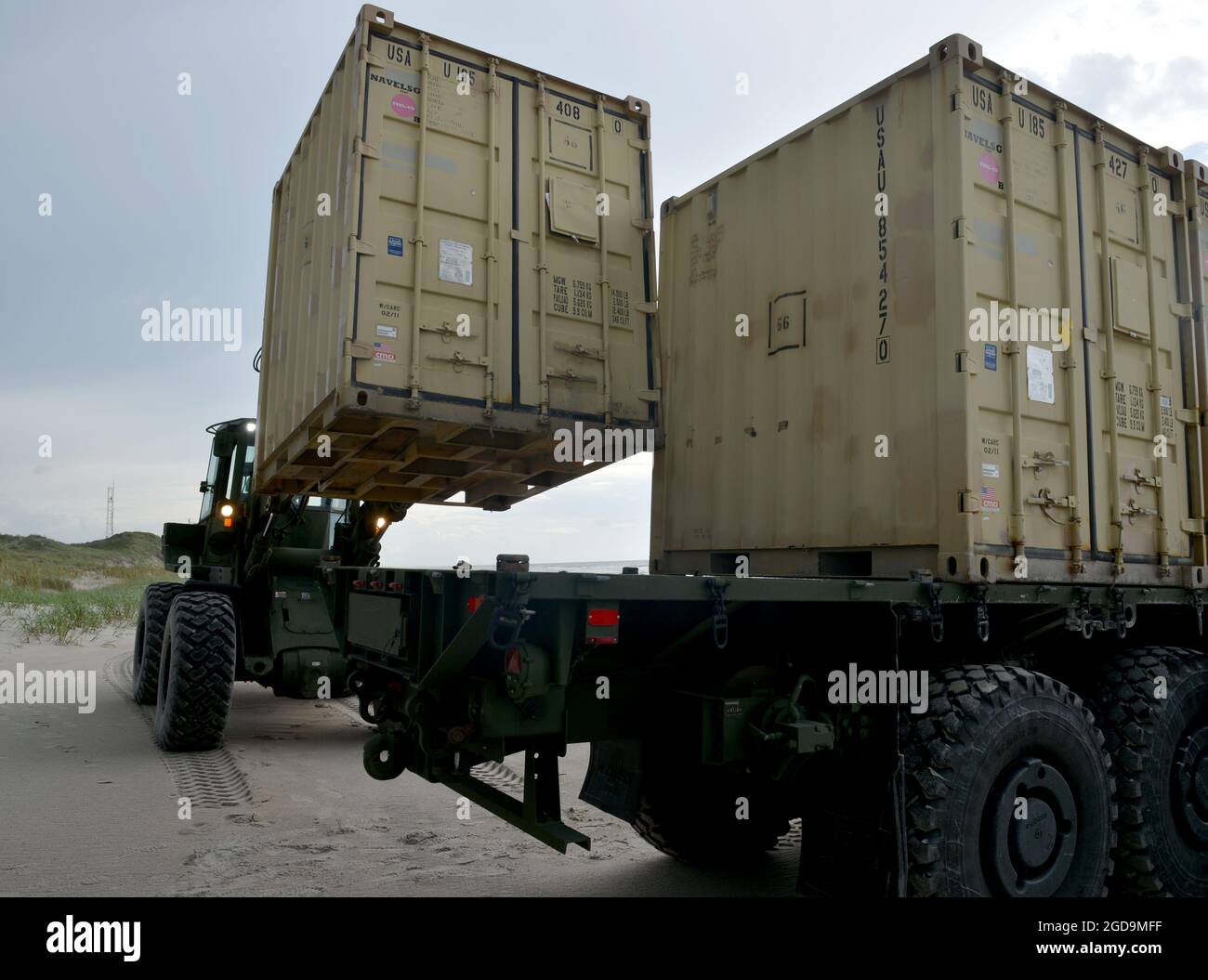 Sailors from Navy Cargo Handling Battalion ONE unload gear for the distributed littoral operational fuel transfer system (DLOFTS) on Onslow beach, N.C. as part of Large-Scale Exercise (LSE 2021), Aug. 7, 2021. LSE 2021 demonstrates the Navy’s ability to employ precise, lethal, and overwhelming force globally across three naval component commands, five numbered fleets, and 17 time zones. LSE 2021 merges live and synthetic training capabilities to create an intense, robust training environment. It will connect high-fidelity training and real-world operations, to build knowledge and skills needed Stock Photo