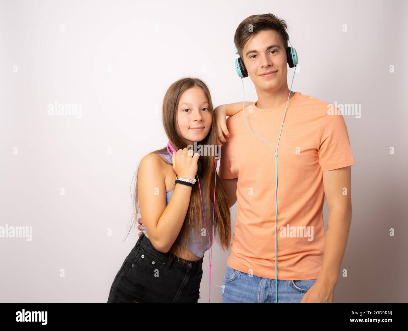 Portrait of young caucasian people boy and girl smiling with headphones ...