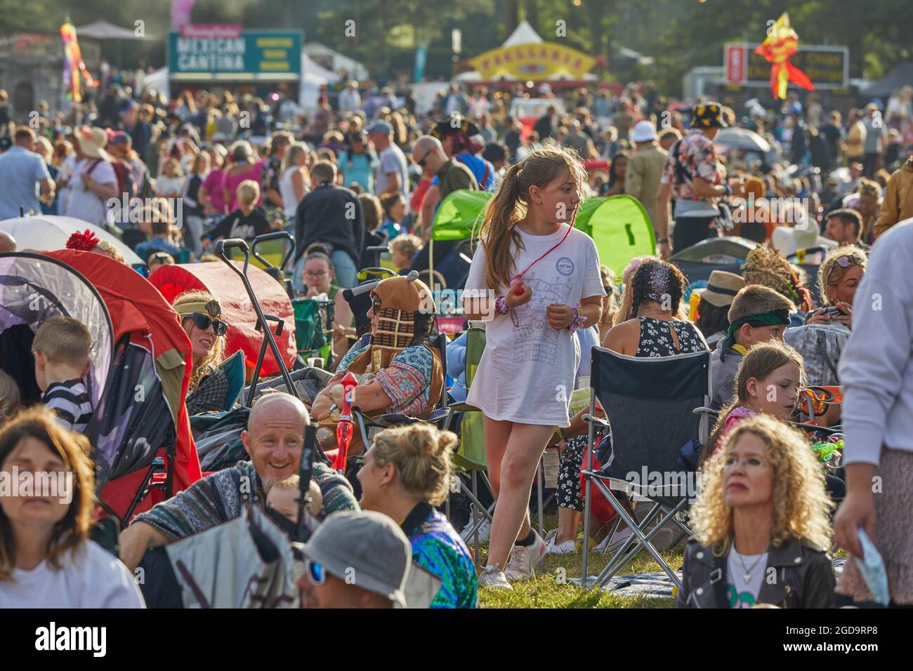 People in the crowd at an outdoor summer music festival. Camp Bestival, Lulworth, Dorset, Great Britain. Stock Photo