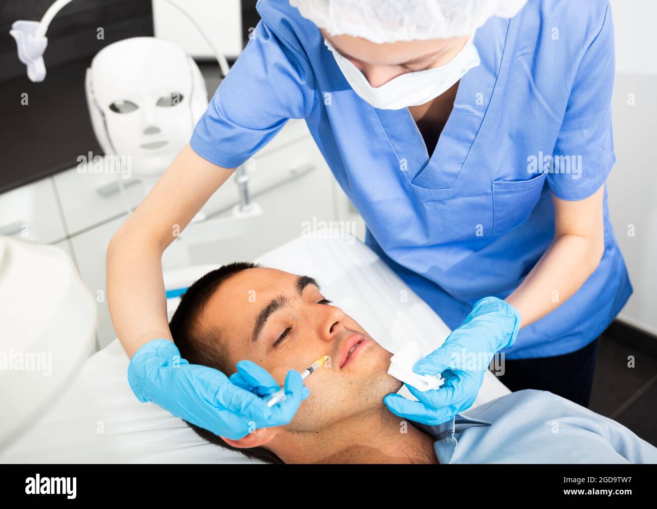 Man receiving injections for facial contouring in cosmetology clinic Stock Photo Alamy