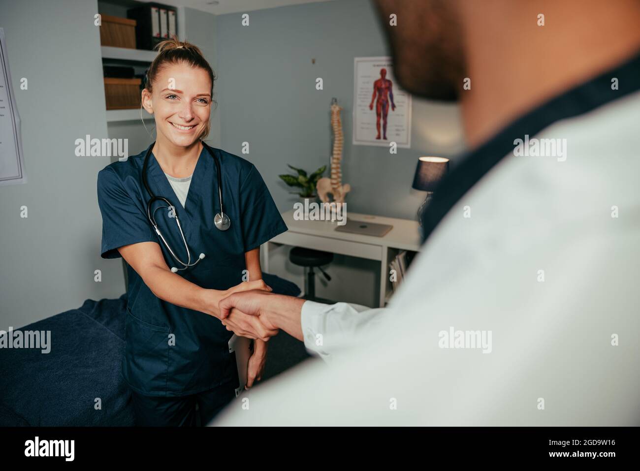 Caucasian female nurse shaking hands with male doctor  Stock Photo