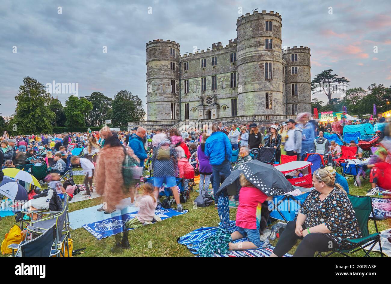Members of a music festival audience in front of Lulworth Castle, at Camp Bestival, Lulworth, Dorset, Great Britain. Stock Photo