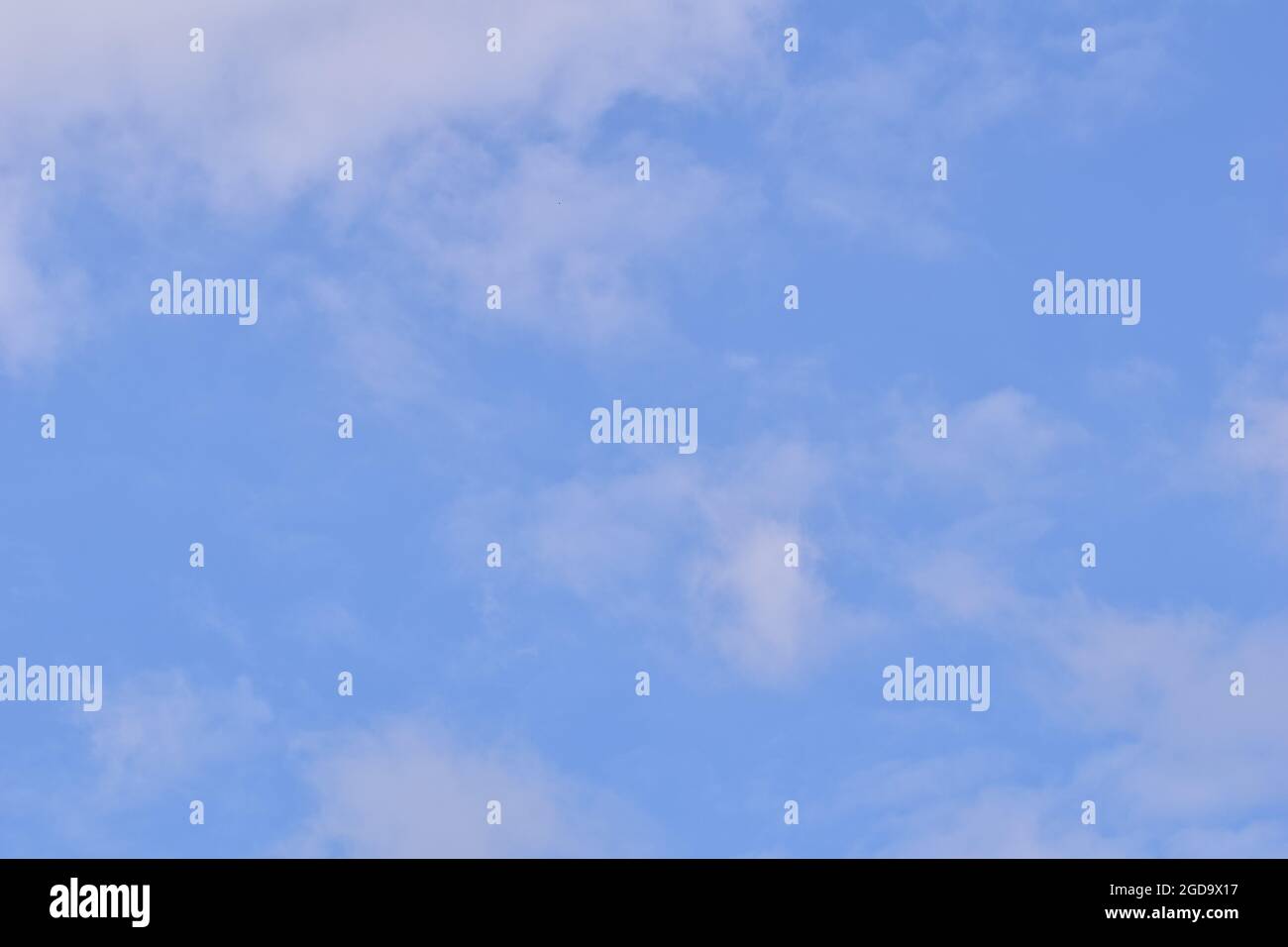 Wide blue sky with a few white clouds Stock Photo