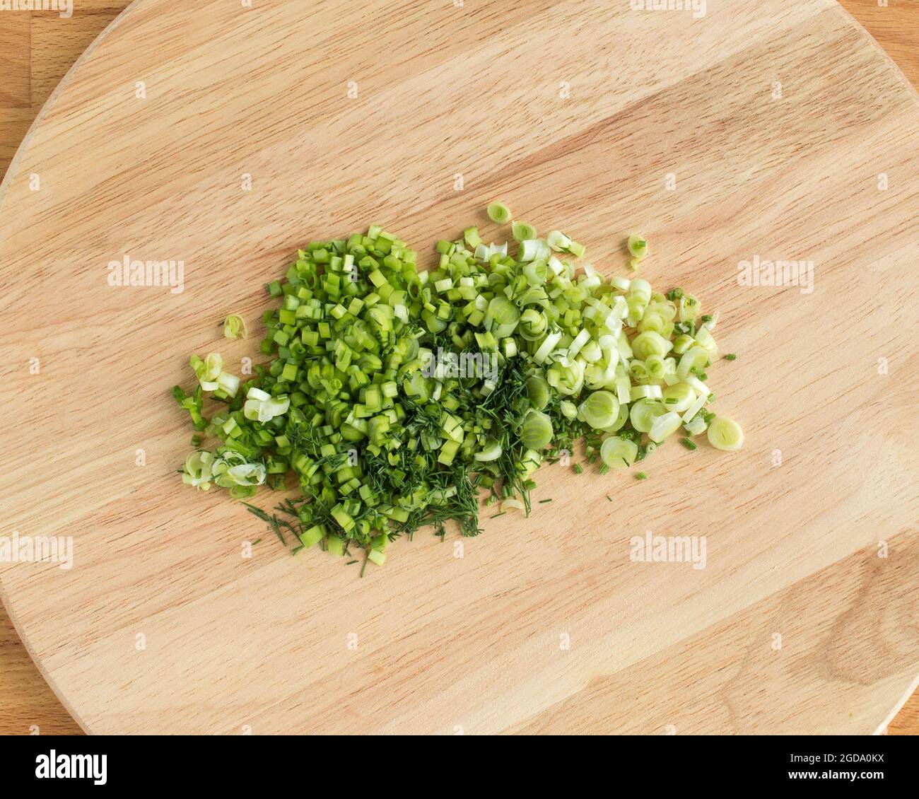 Sliced green onions on a cutting board.light, bright, no people, no one ...