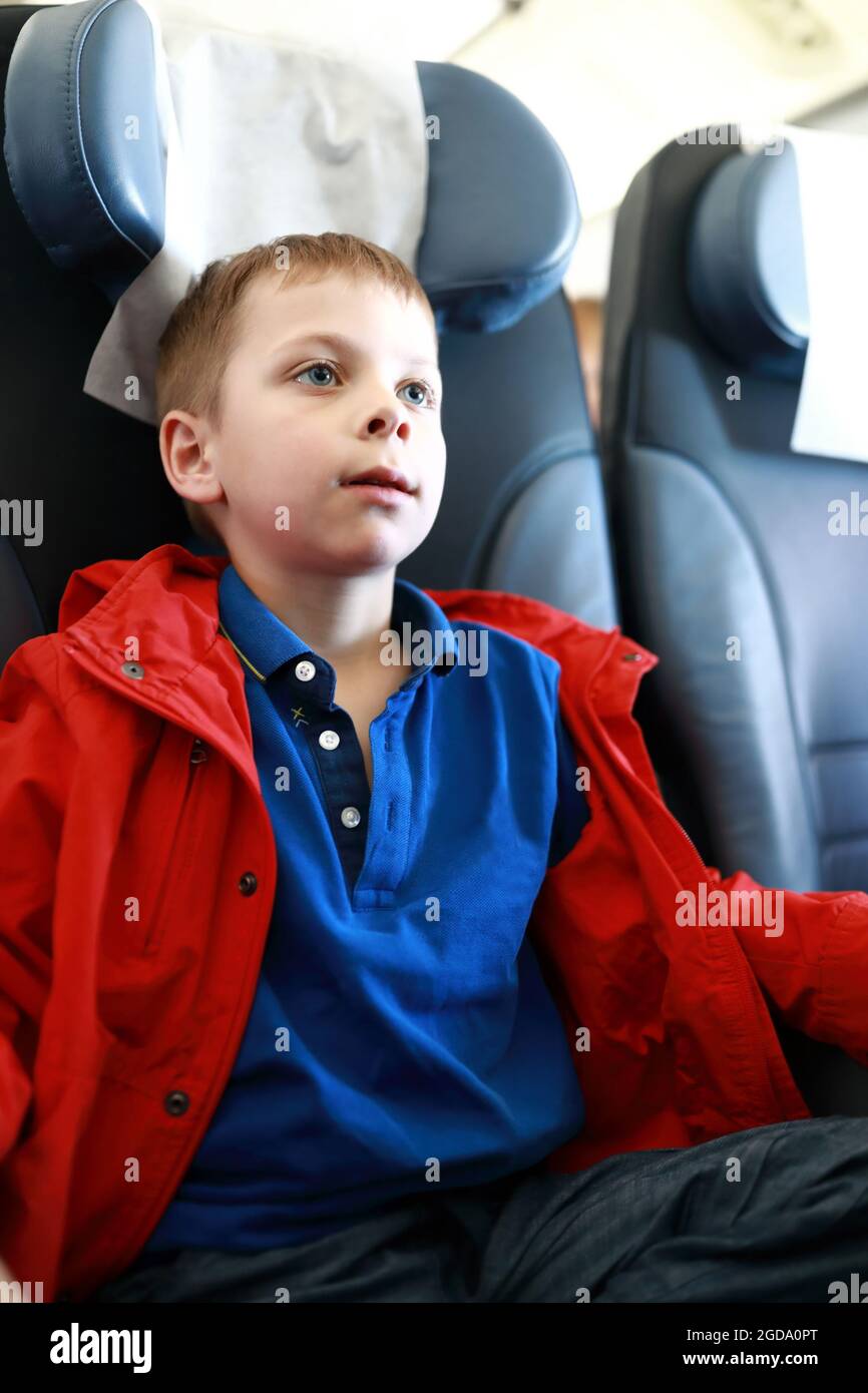 Portrait of serious child on board airplane Stock Photo Alamy