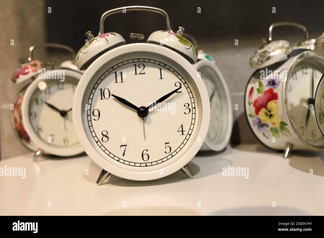 Round alarm clocks on shelf in store Stock Photo Alamy