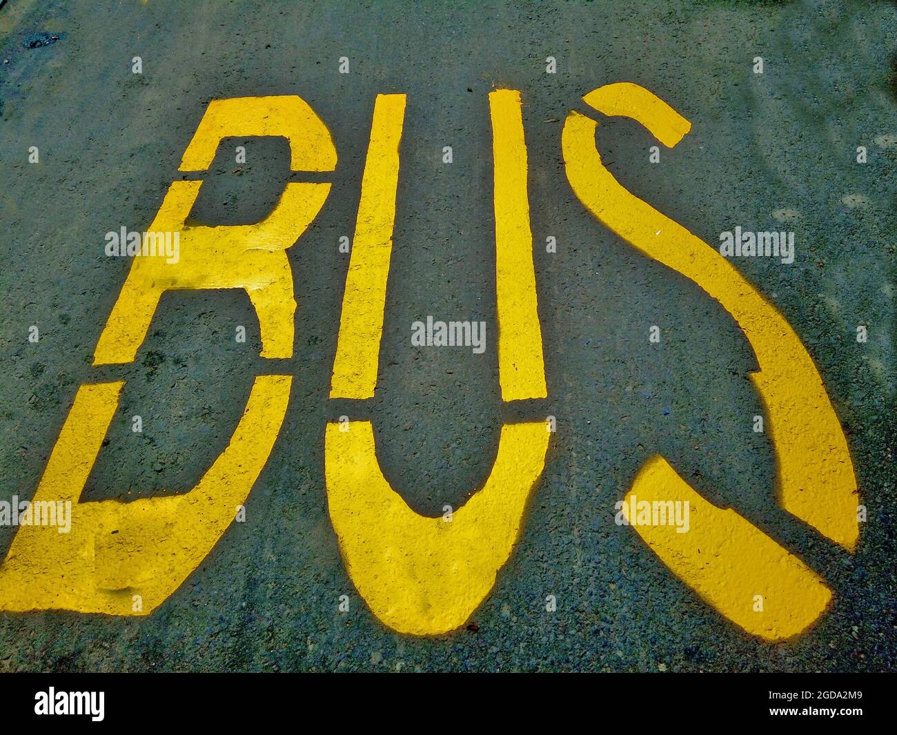 the word bus painted in a station on asphalt Stock Photo