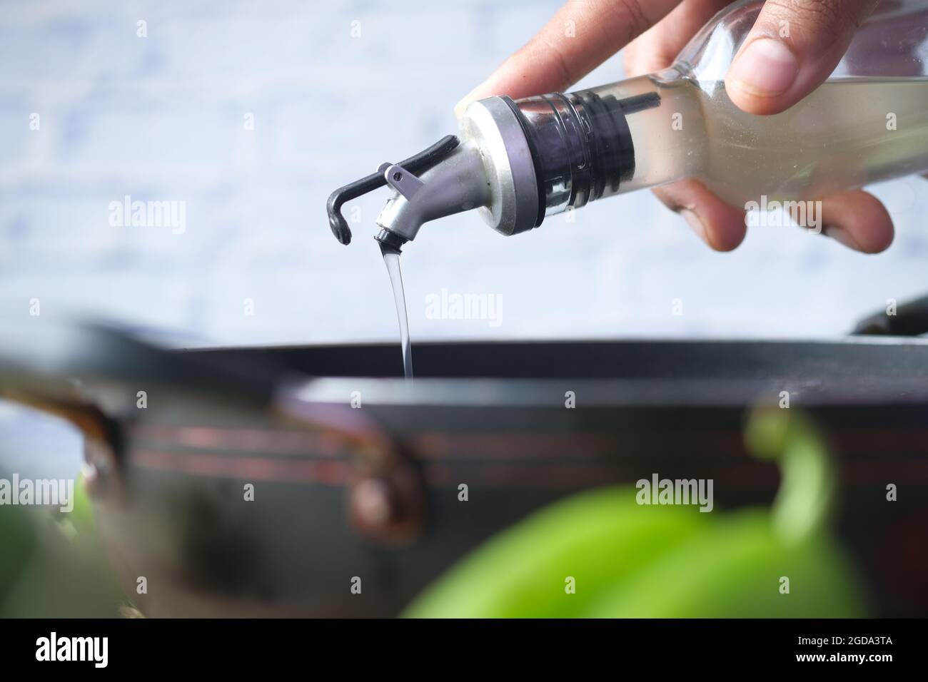 Pouring vegetable oil into frying pan Stock Photo Alamy