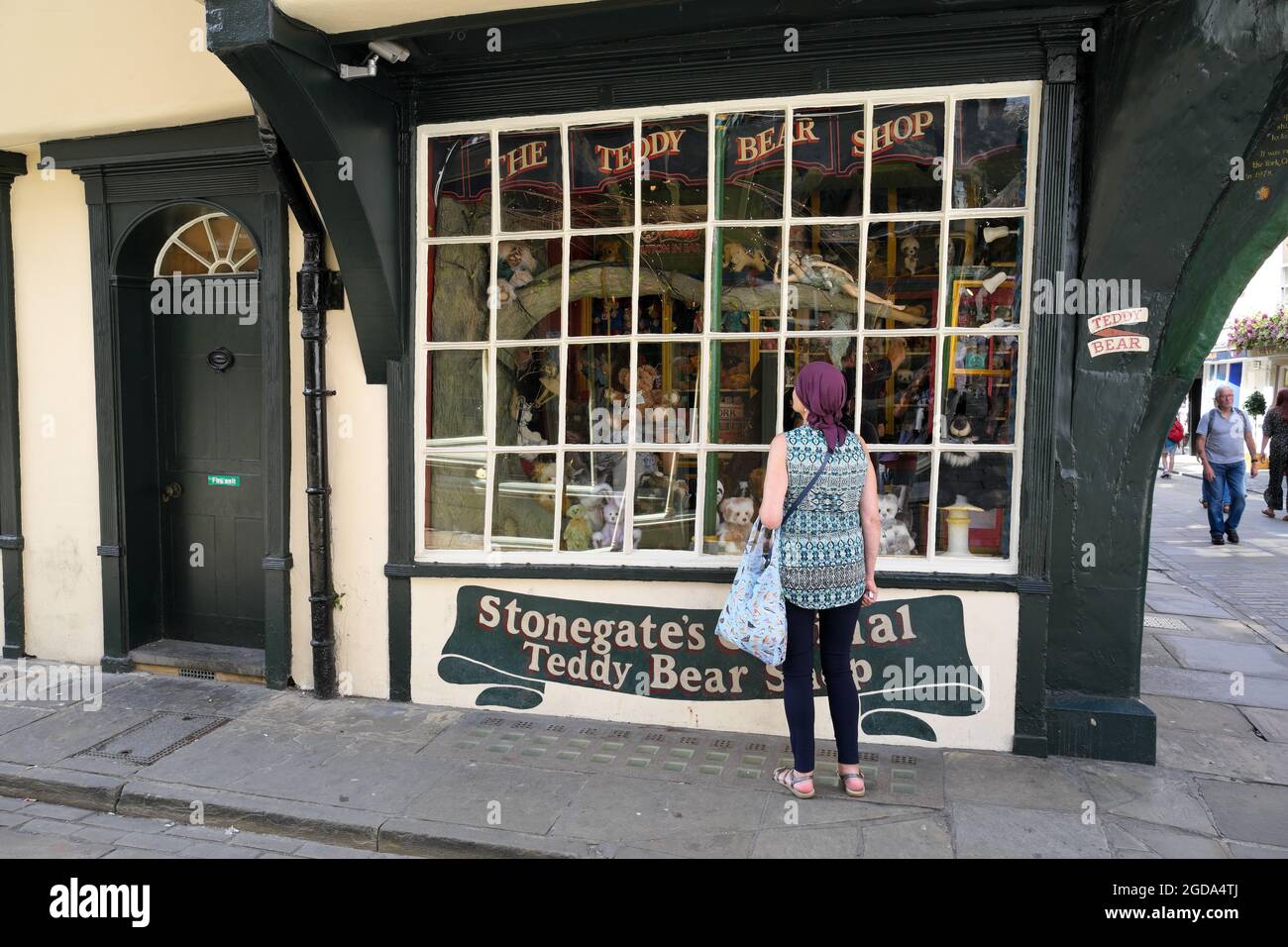 Woman Looking In The Shop Window Of Stonegate's Original Teddy Bear Shop In The City Of York Yorkshire England UK Stock Photo