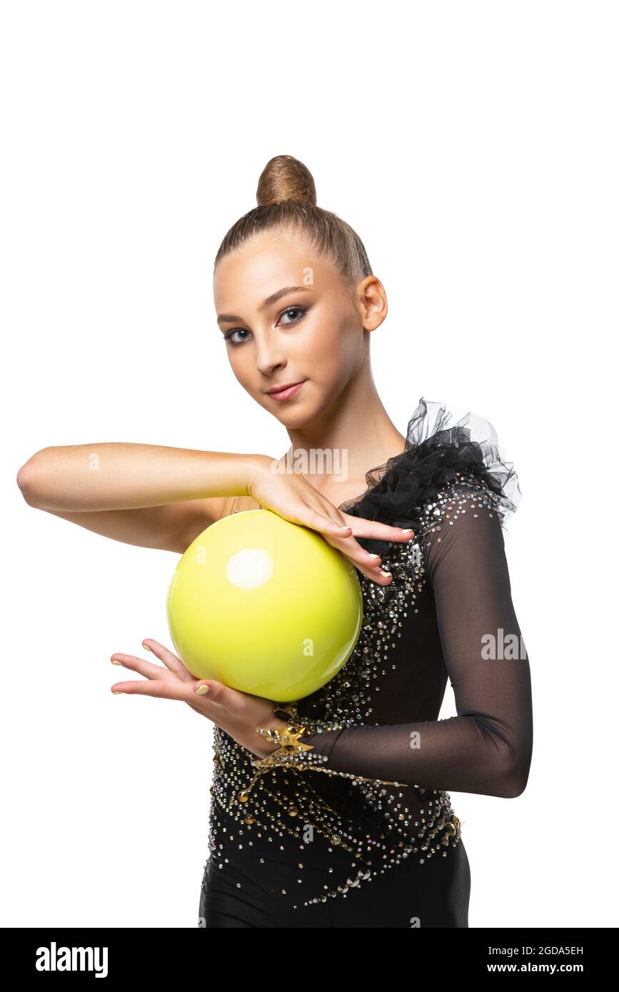 Close-up portrait of young rhythmic gymnastics artist in stage costume isolated on white studio background. Concept of sport, action, active lifestyle Stock Photo