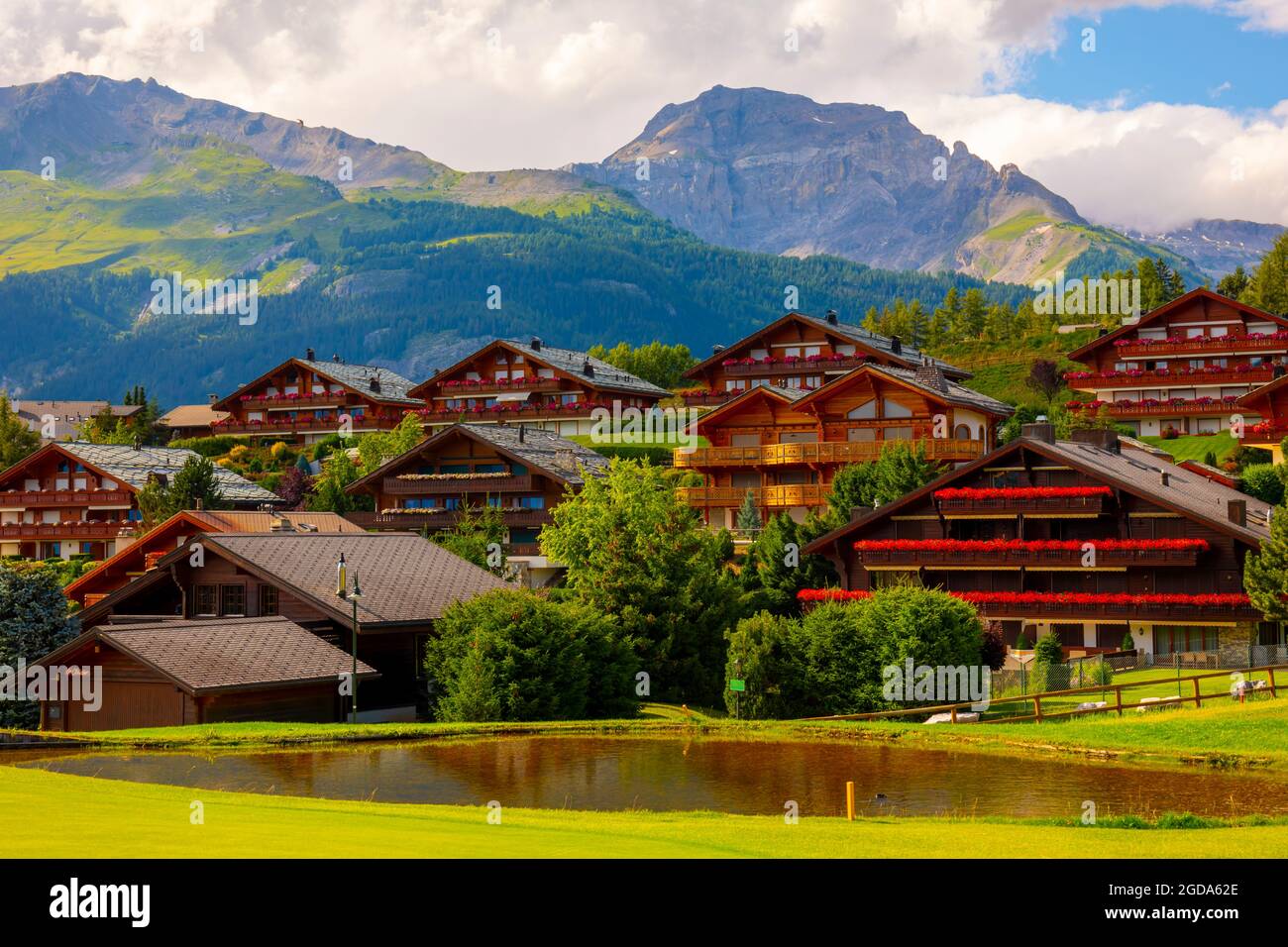 Crans Sur Sierre Golf Course with House and Mountain View in Crans Montana in Valais, Switzerland. Stock Photo