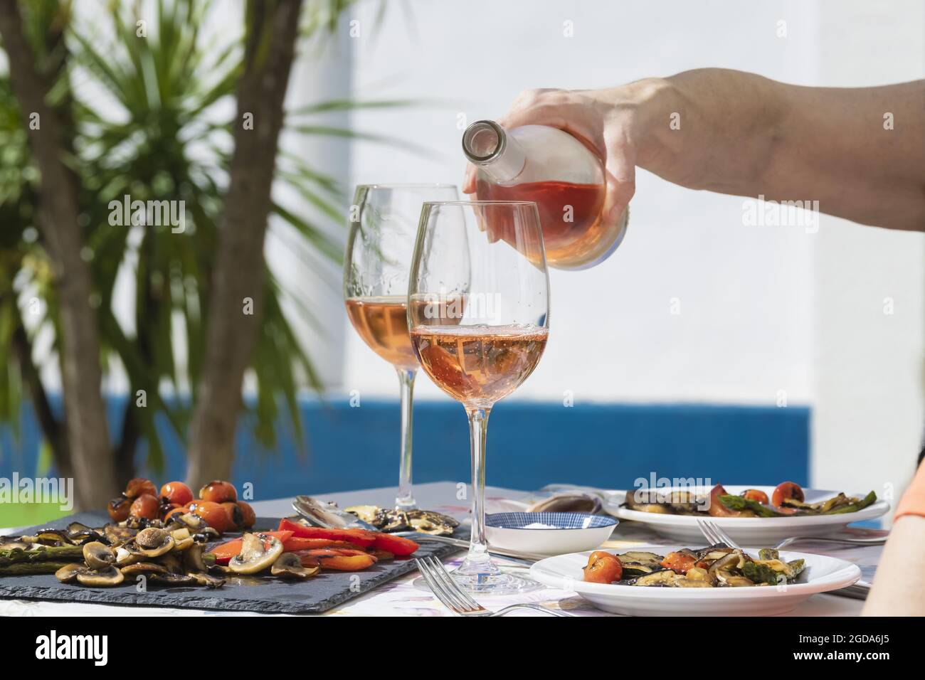 a hand of woman pouring rose wine Stock Photo - Alamy
