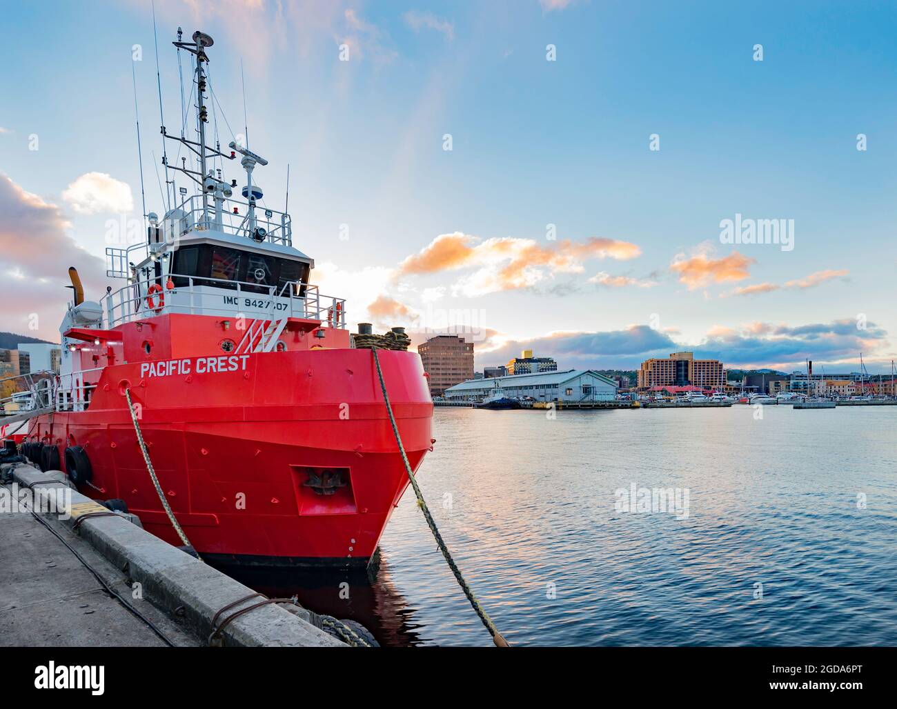 The ocean tug Pacific Crest moored in the late afternoon beside the Institute for Marine and Antarctic Studies building in Hobart, Tasmania, Australia Stock Photo