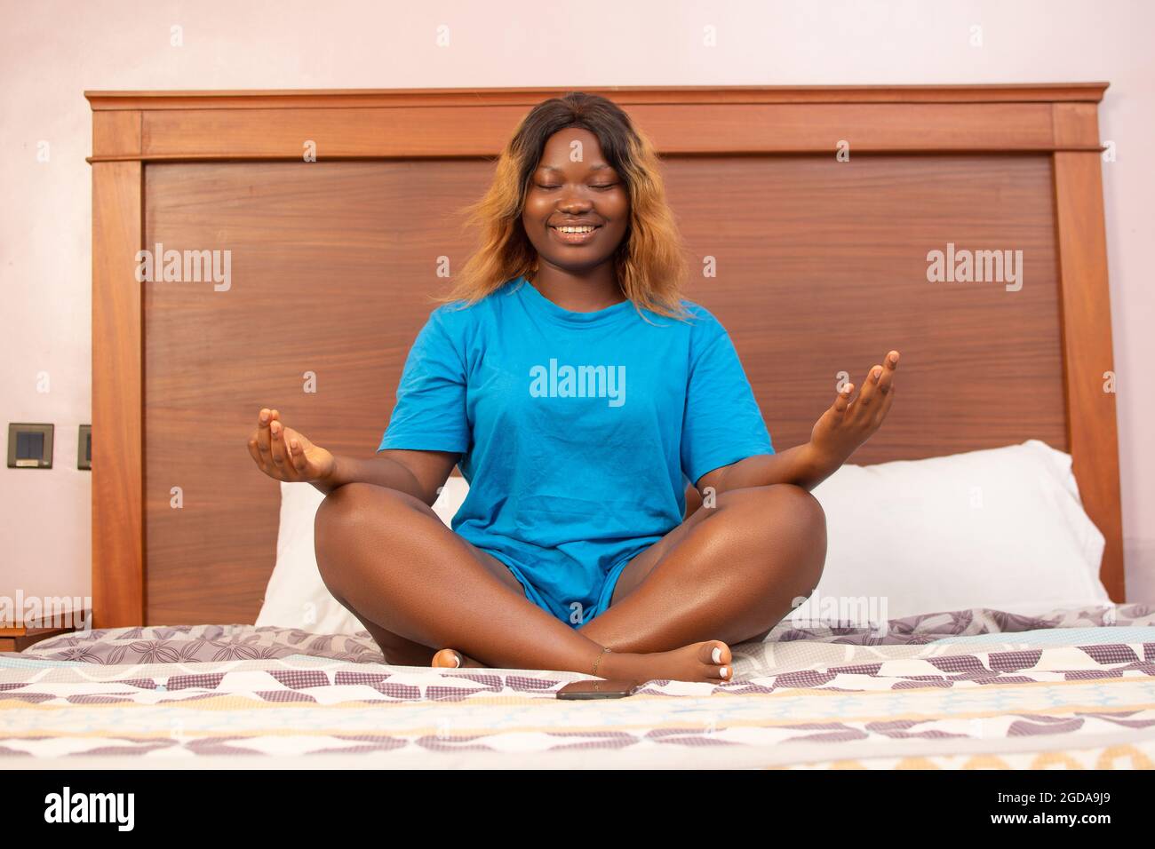 Little girl sitting in yoga pose Stock Photo - Alamy