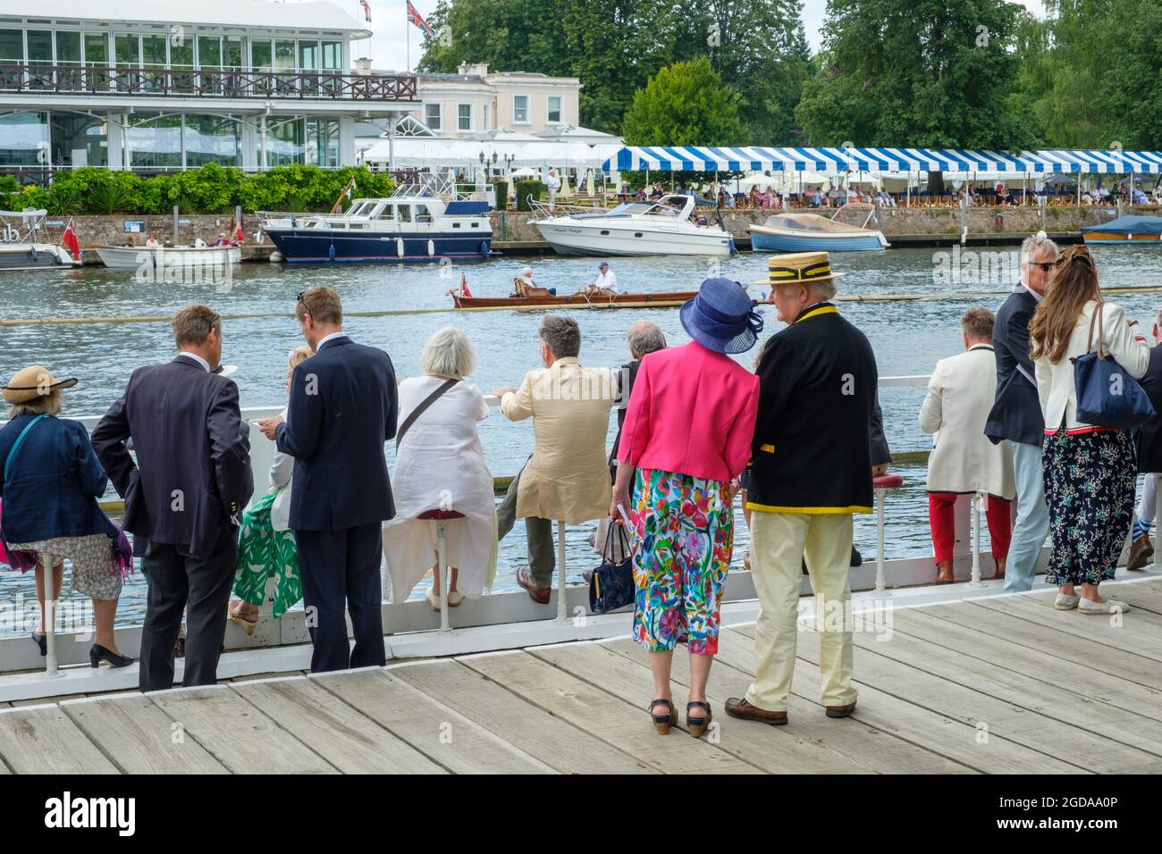 Spectators in the Stewards Enclosure at the 2021 Henley Royal Regatta with Phyllis Court opposite Stock Photo