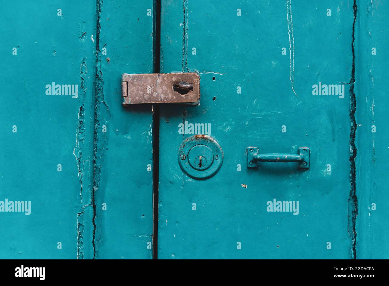 Antique iron padlock closing a wooden door or window in color. Pelourinho, Salvador, Bahia, Brazil. Stock Photo