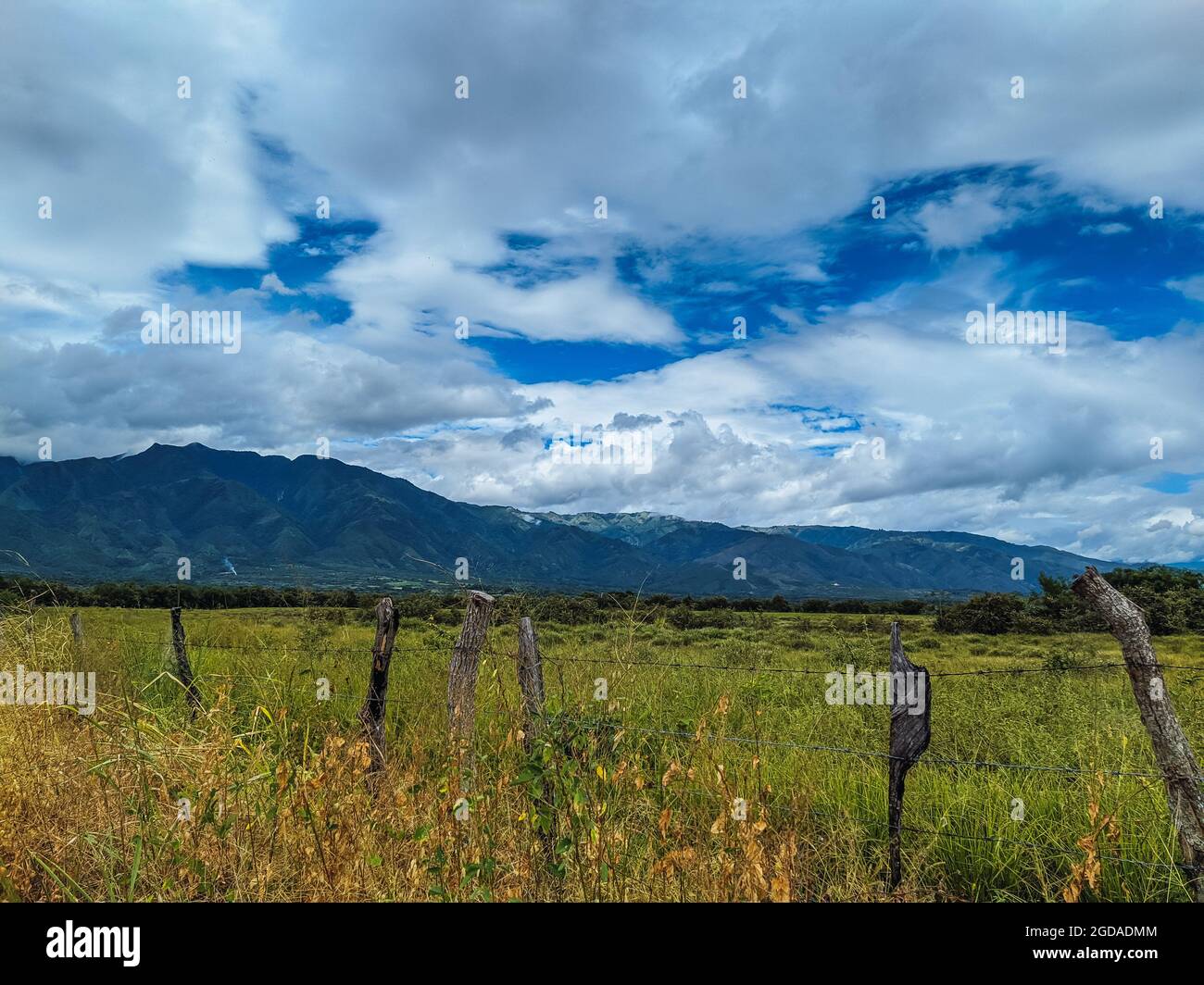 Scenery of a rural field surrounded by hills on a cloudy day Stock ...