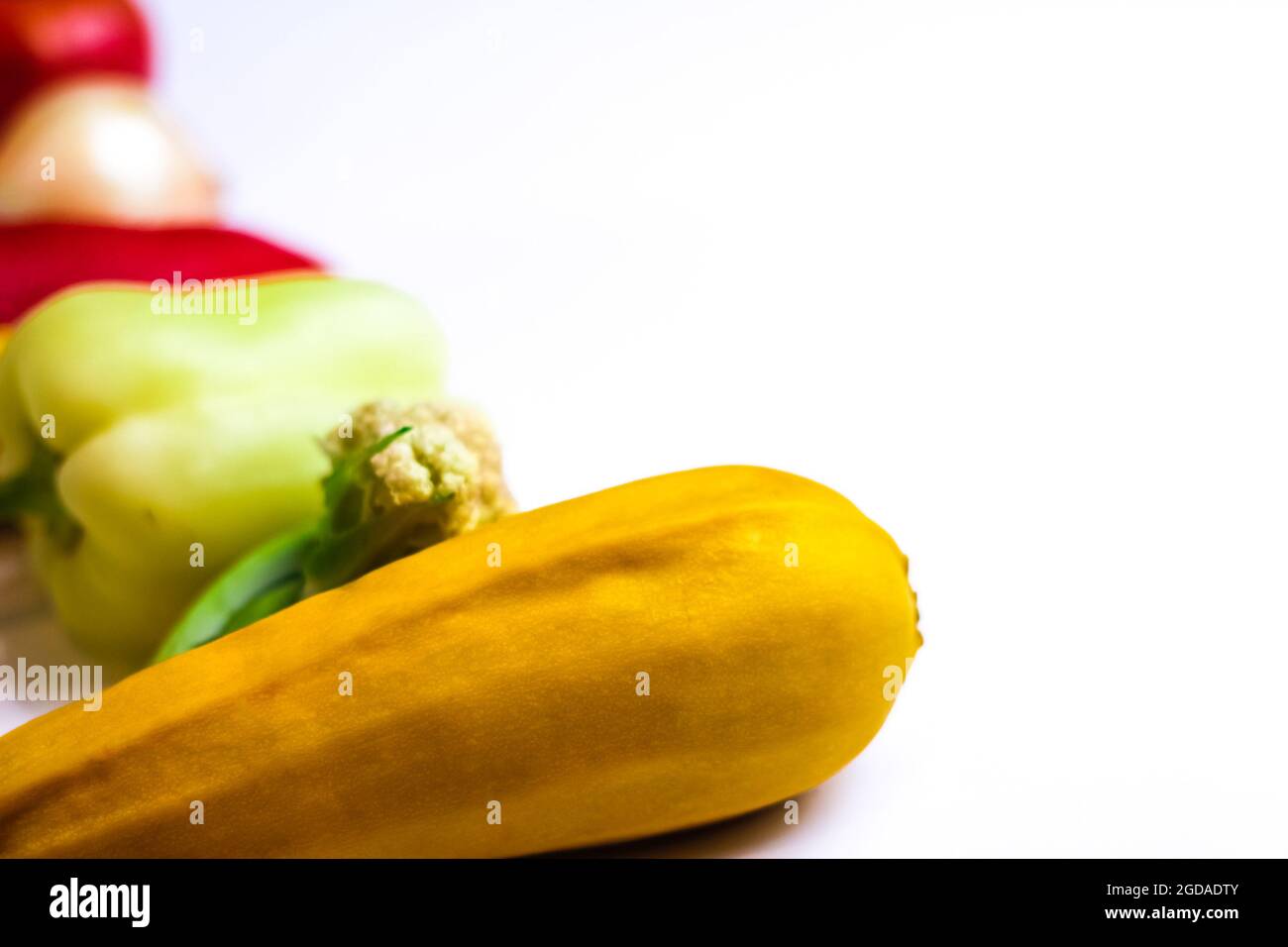 Ripe imperfect squash on blur vegetable background. Autumn still life with variety of colorful vegetables on white background. Happy Thanksgiving. Sel Stock Photo