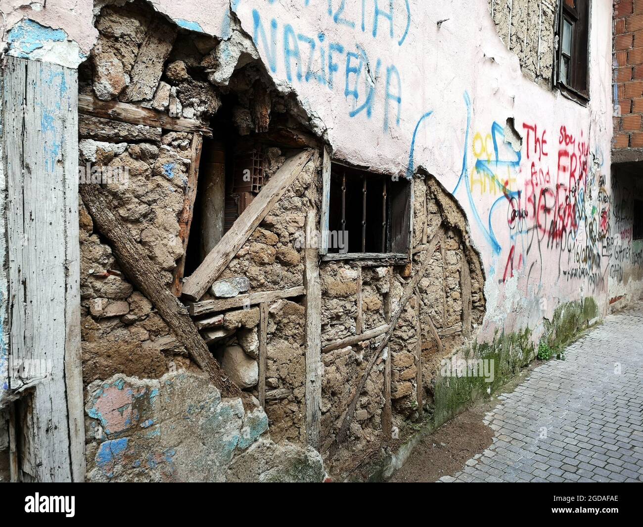 Closeup of an old abandoned building with colorful letterings on the exterior wall Stock Photo