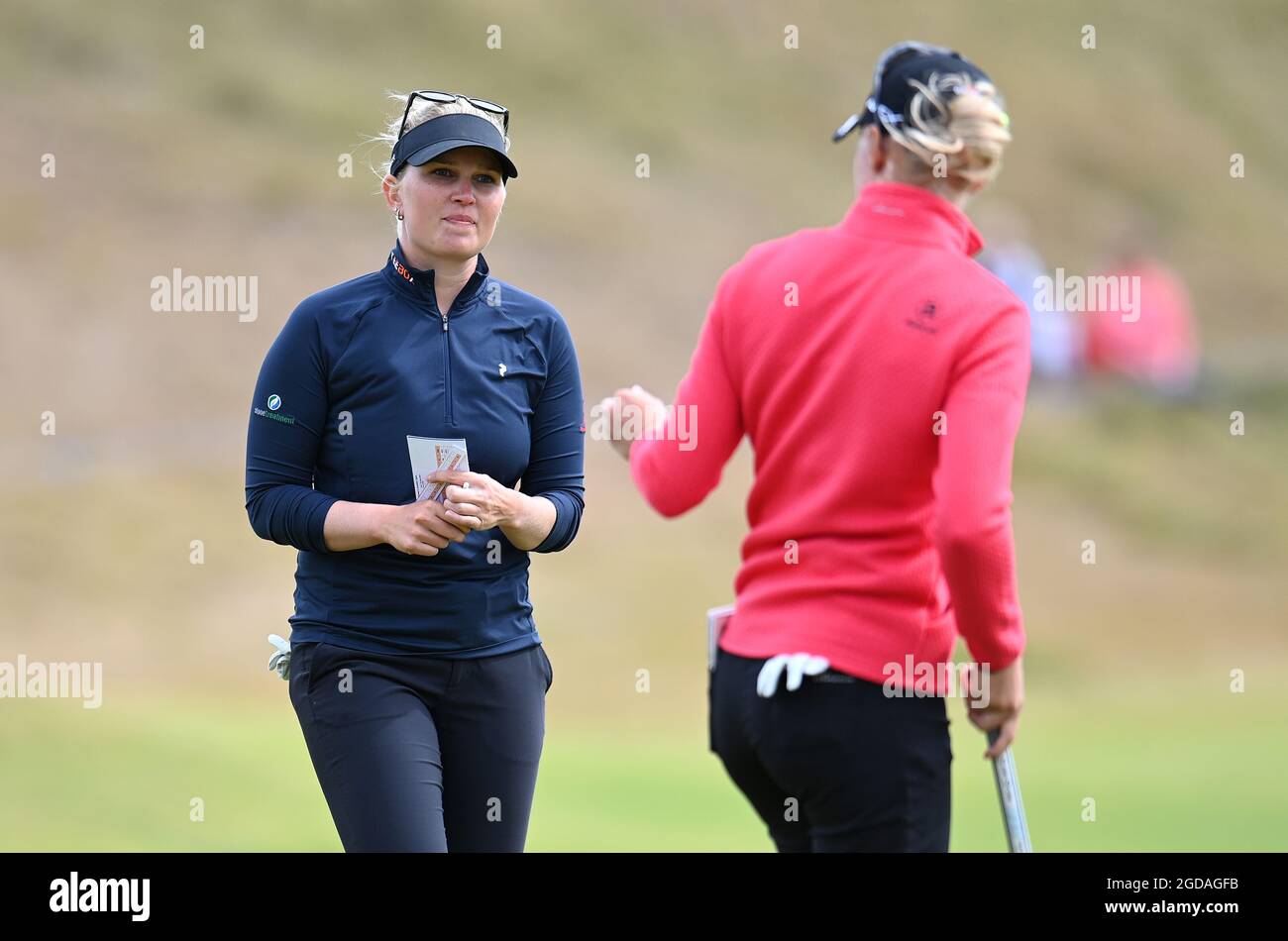 Denmark's Nanna Koerstz Madsen (left) and Sweden's Madelene Sagstrom on the 18th green during day one of the Trust Golf Women's Scottish Open at Dumbarnie Links, St Andrews. Picture date: Wednesday August 11, 2021. Stock Photo