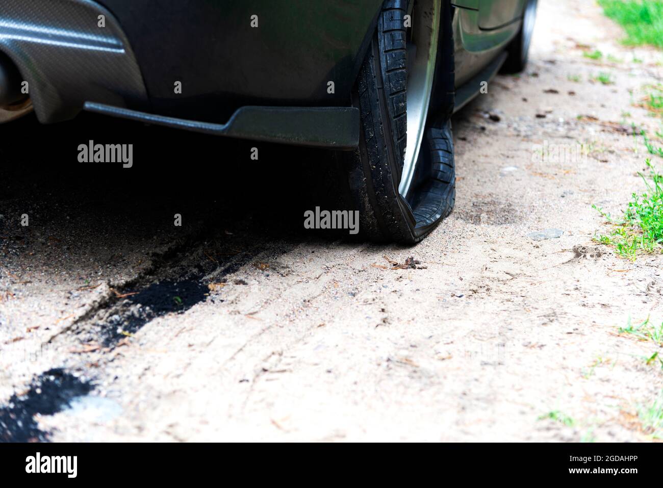 Punctured wheel of a modern car on the road. Car tire puncture Stock