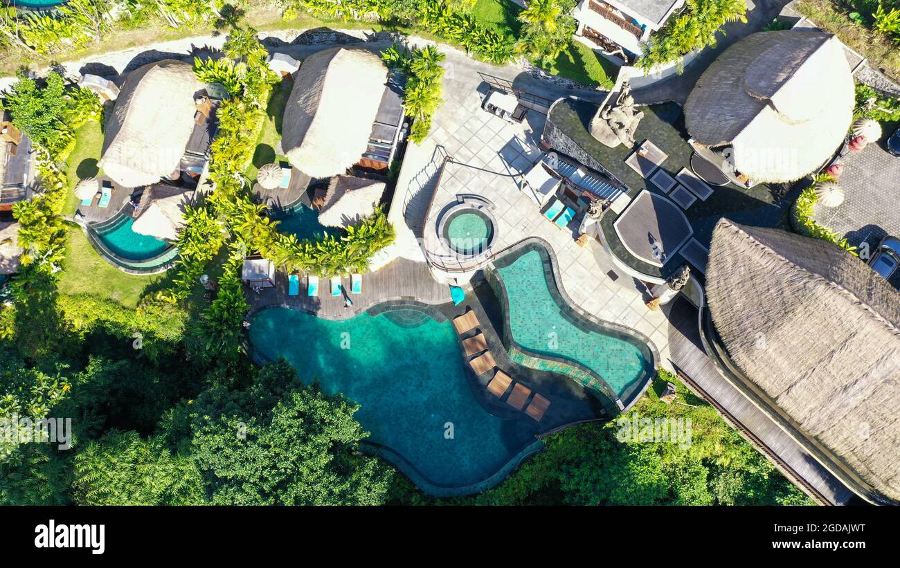 Aerial view of luxury hotel with villas and pool in tropical jungle and ...