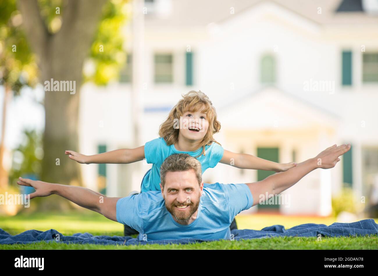 family value. childhood and parenthood. parent rest with little child boy on grass Stock Photo