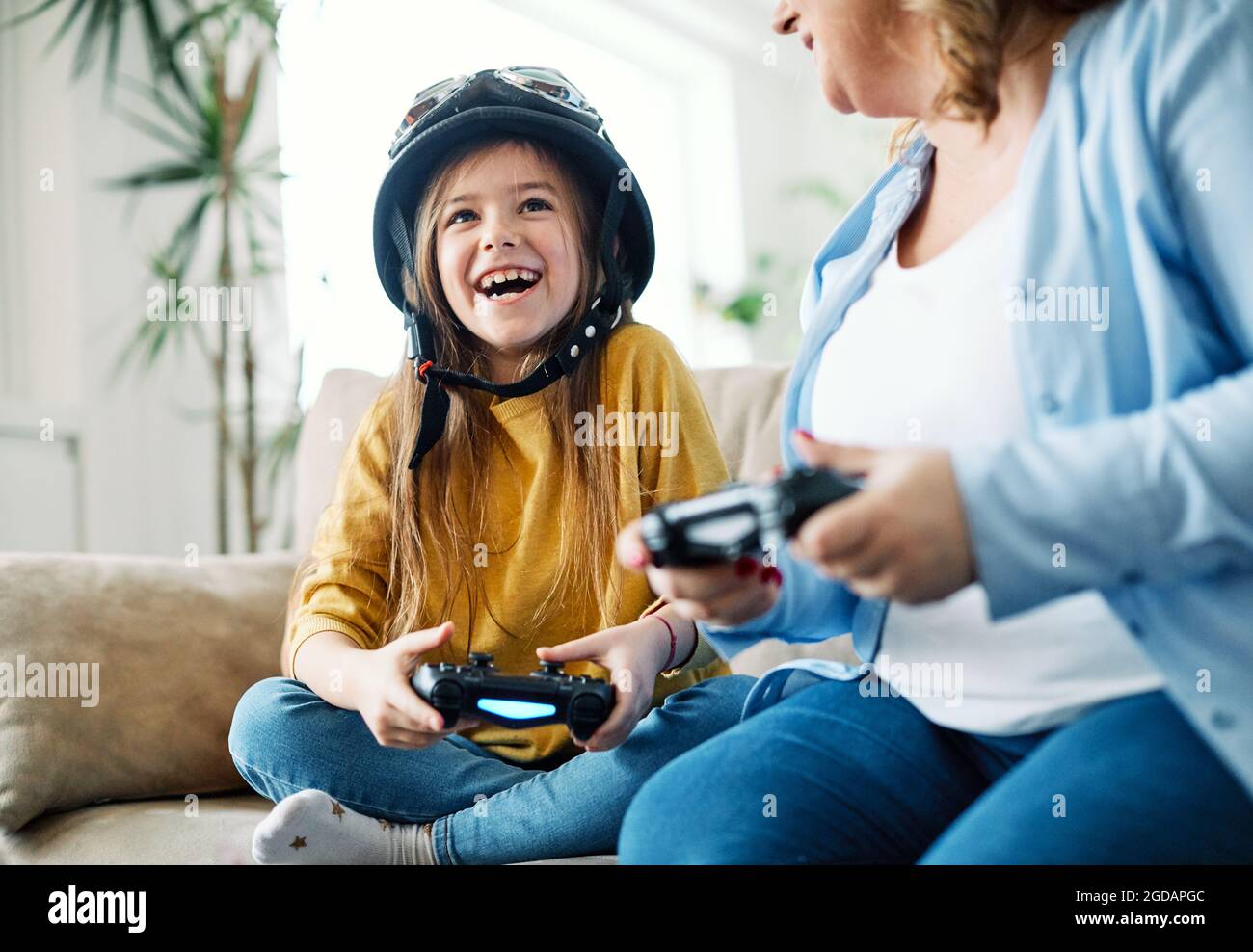 child daughter mother family happy playing console kid childhood Stock Photo
