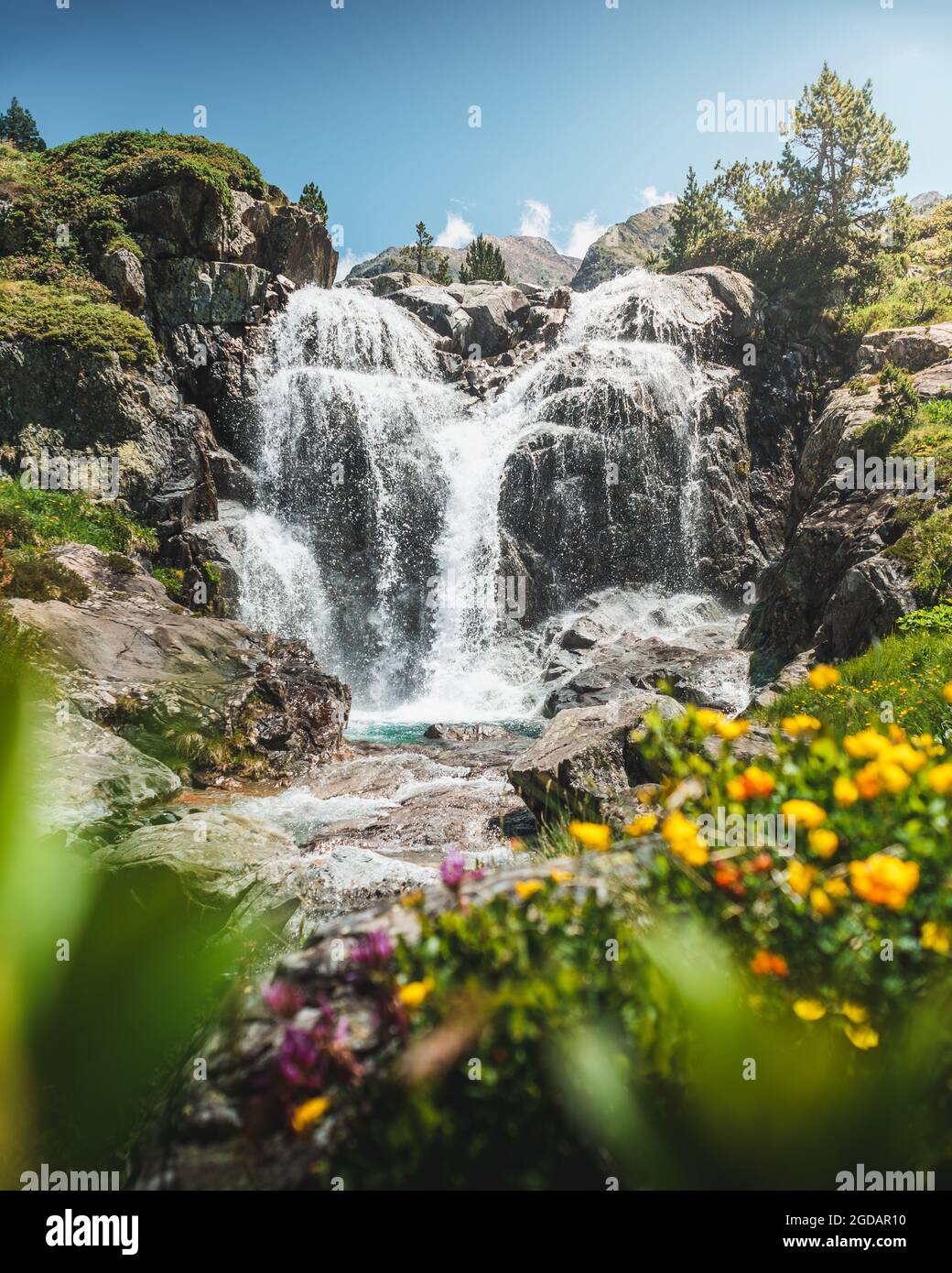 Vertical shot of a small waterfall flowing over the rocks Stock Photo ...