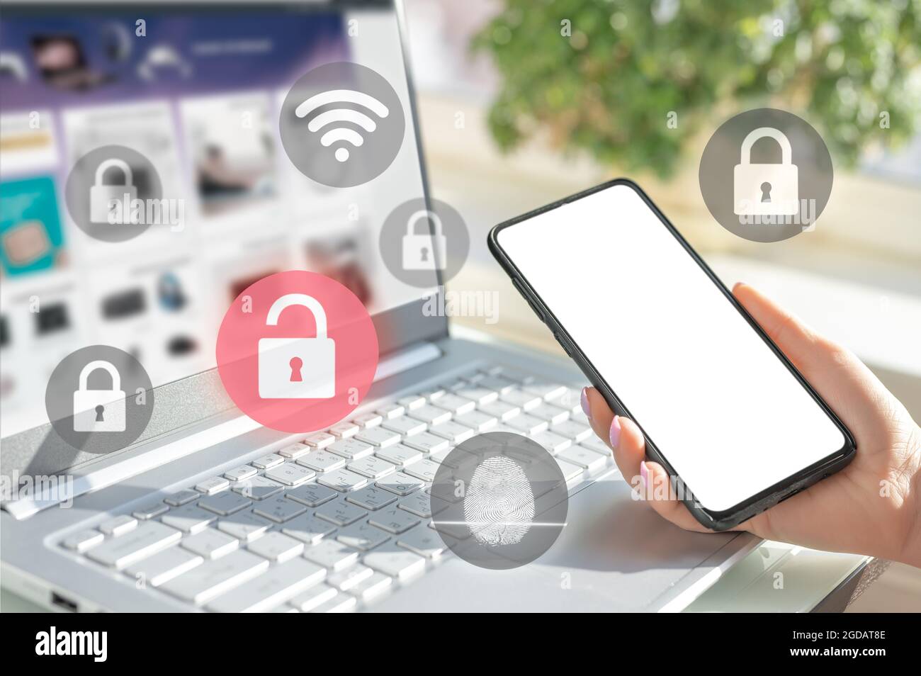 mockup cellphone. businesswoman hold cell phone. woman logging in laptop and holding smartphone on hand with security key lock icon on screen. Privacy Stock Photo